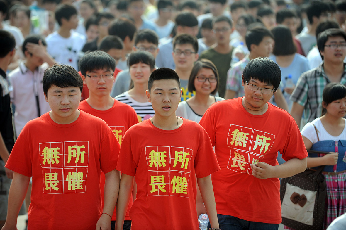 Students wearing T-shirts saying 'fear nothing' walk into the exam room to sit the 2014 college entrance exam in Bozhou, east China's Anhui province.