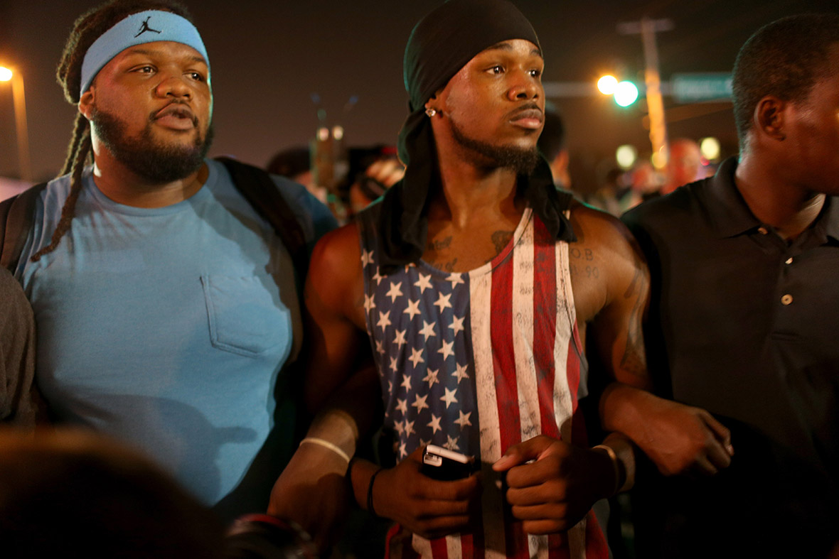 A demonstrator wearing a stars and stripes vest takes part in a protest in Ferguson, Missouri