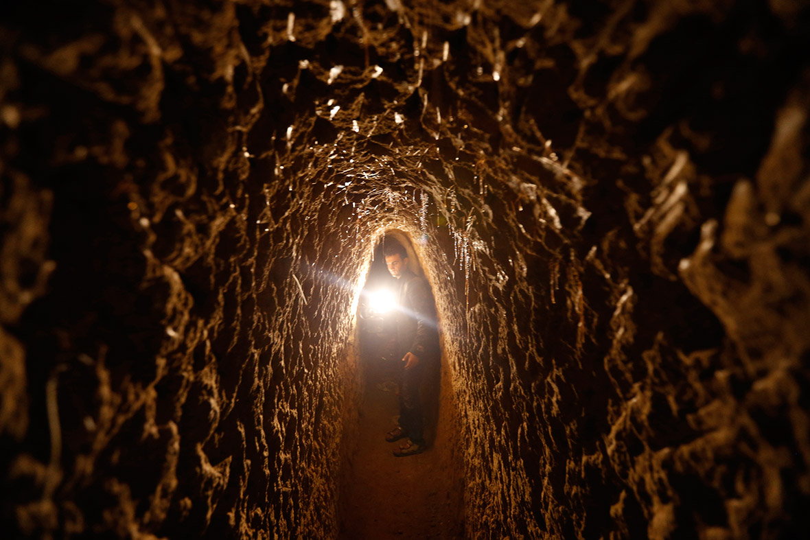 A journalist tours a tunnel that was dug underneath a neighbourhood close to the residential compound of Yemen's former president Ali Abdullah Saleh, in Sanaa