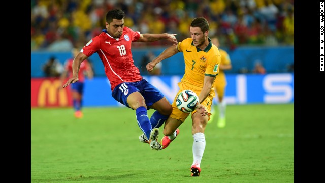 Chilean defender Gonzalo Jara, left, clashes with Australian forward Mathew Leckie.