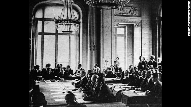 German delegates listen to French Prime Minister Georges Clemenceau's speech during the signing of the Treaty of Versailles in France on June 28, 1919.