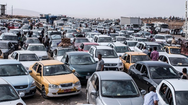 Automobiles clog a highway as refugees flee Mosul, Iraq, on Tuesday, June 10. More than 500,000 residents have fled in fear after extremist militants overran Iraq's second-largest city, according to the International Organization for Migration.