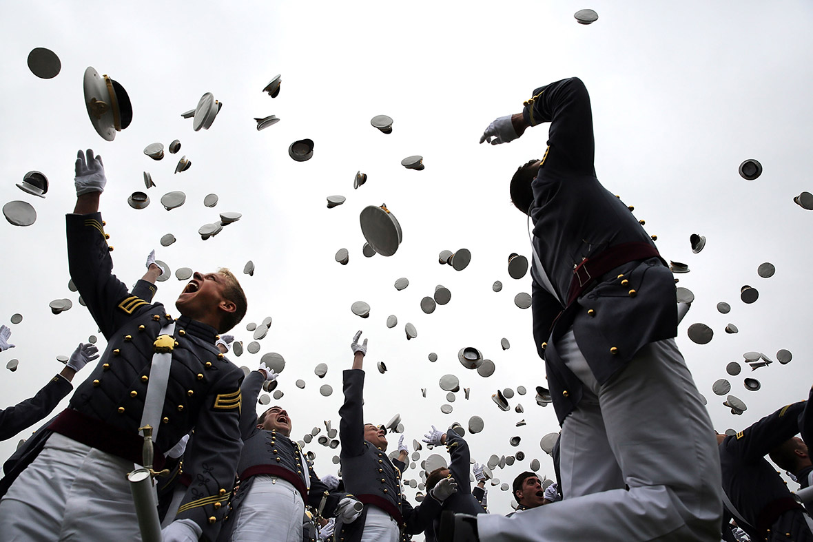 Cadets throw their hats in the air at the conclusion of their graduation ceremony at the US Military Academy in West Point, New York