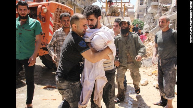 The father of a 3-month-old girl weeps as he takes her body Monday, May 26, after she's pulled from rubble in Aleppo following a barrel bomb strike reportedly by government forces.