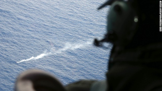 A member of the Royal New Zealand Air Force looks at a flare in the Indian Ocean during search operations on Friday, April 4.
