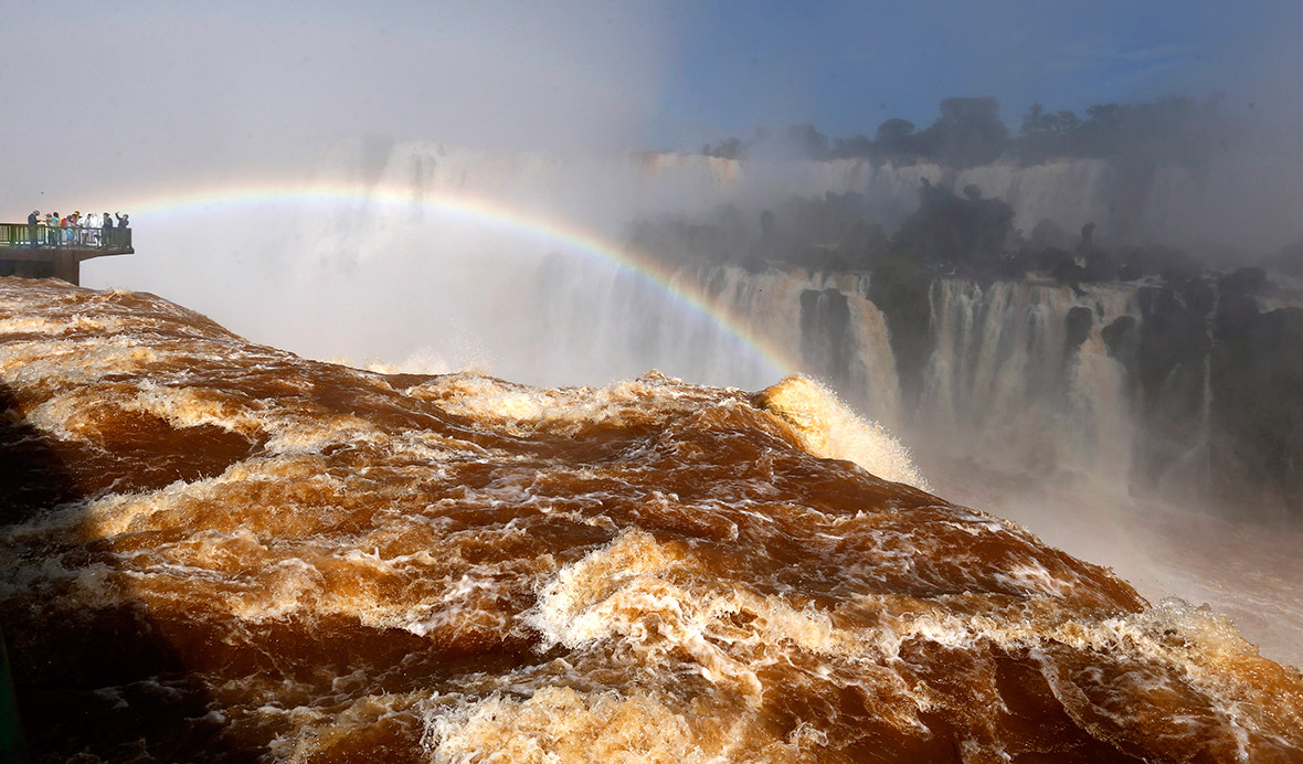 Tourists view the Iguazu Falls from an observation platform at the Iguazu National Park on the border between Argentina and Brazil