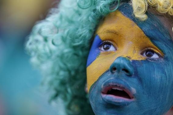 A fan of Brazil reacts while watching a broadcast of the 2014 World Cup semi-final against Germany at the Fan Fest in Brasilia, July 8, 2014. REUTERS/Ueslei Marcelino