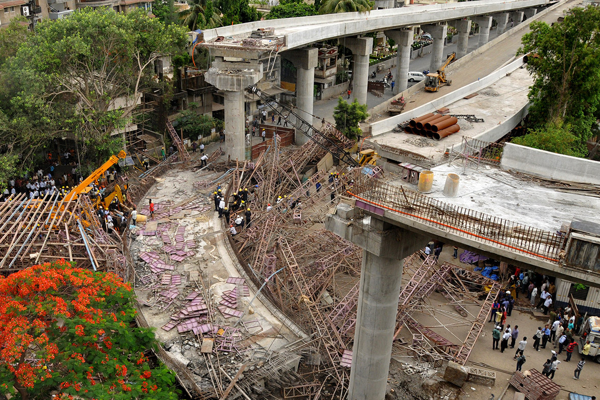 Rescue workers search for people after a huge portion of an under-construction flyover bridge collapsed in Surat, India.