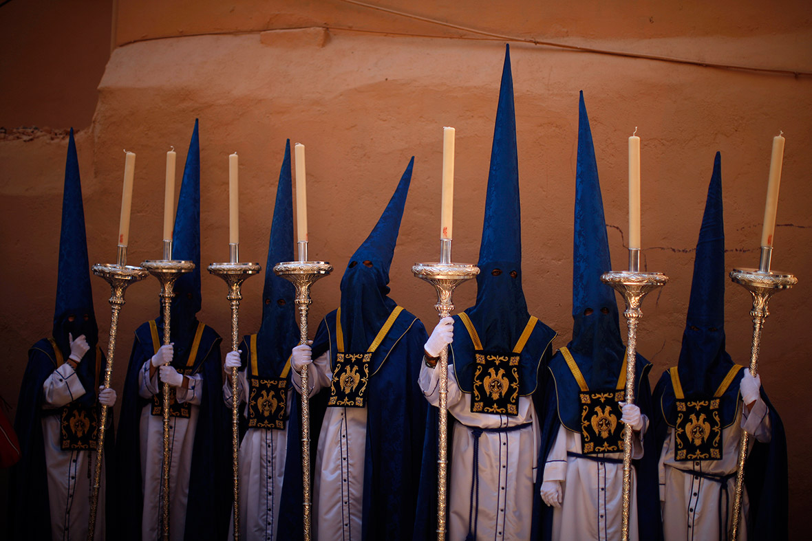 Hooded penitents take part in a Palm Sunday procession in Malaga during Holy Week