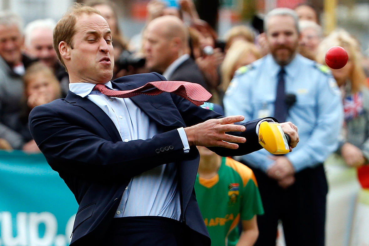 Prince William tries to hit a ball with a cricket bat as he and Kate Middleton attend a promotional event for the upcoming Cricket World Cup in Christchurch