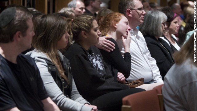 People gather to mourn the shooting victims April 13 at St. Thomas the Apostle, an Episcopal church in Overland Park. Overland Park is a suburb of Kansas City.