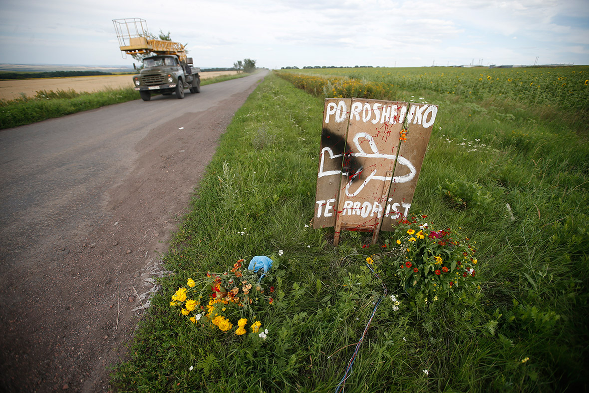 A sign calling Ukrainian President Petro Poroshenko a terrorist is seen near the crash site of Malaysia Airlines Flight MH17
