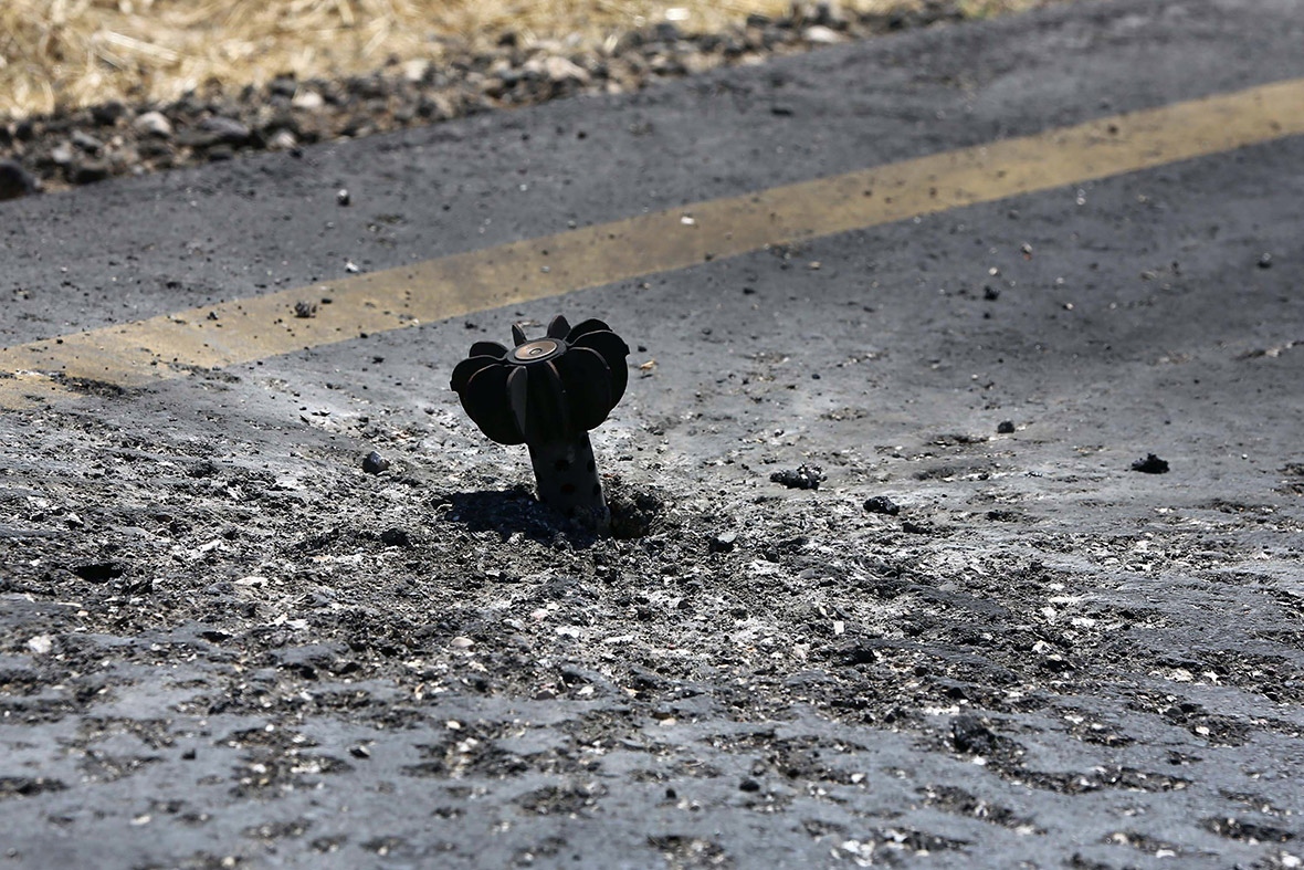 July 16, 2014: An unexploded mortar shell sticks out of the tarmac at Tripoli international airport