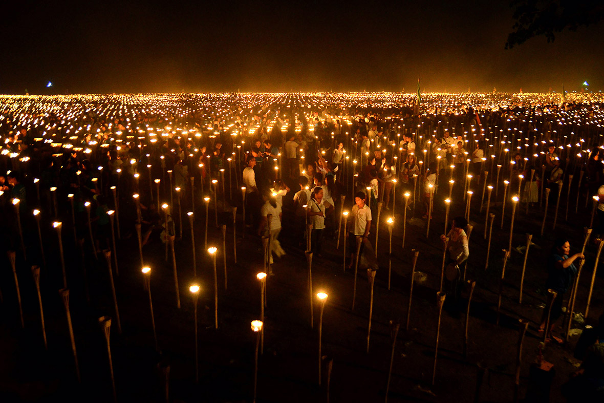 Volunteers light candles during the 