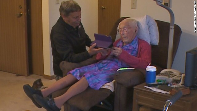 Anna Stoehr, a new Facebook user at age 114, checks out an iPad with the help of friend Joseph Ramireza.