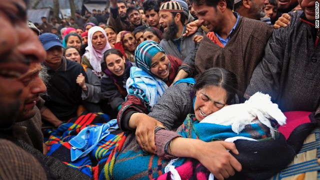 Sumaira Wani, wife of Zia-Ul-Haq, mourns by the body of her husband during his funeral in Hirpora, some 65 kilometers (40 miles) north of Srinagar on Friday, April 25. Zia, an Indian poll official, was killed soon after voting in the ongoing election, when suspected rebels fatally shot him and wounded four others in an attack on a bus in the Indian-controlled portion of Kashmir.