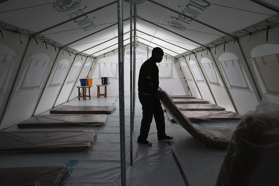 Workers prepare the new Doctors Without Borders (MSF), Ebola treatment centre near Monrovia. The facility has 120 beds, making it the largest centre for Ebola treatment and isolation in history. MSF plans to expand it to 350 beds. The tents were provided by Unicef