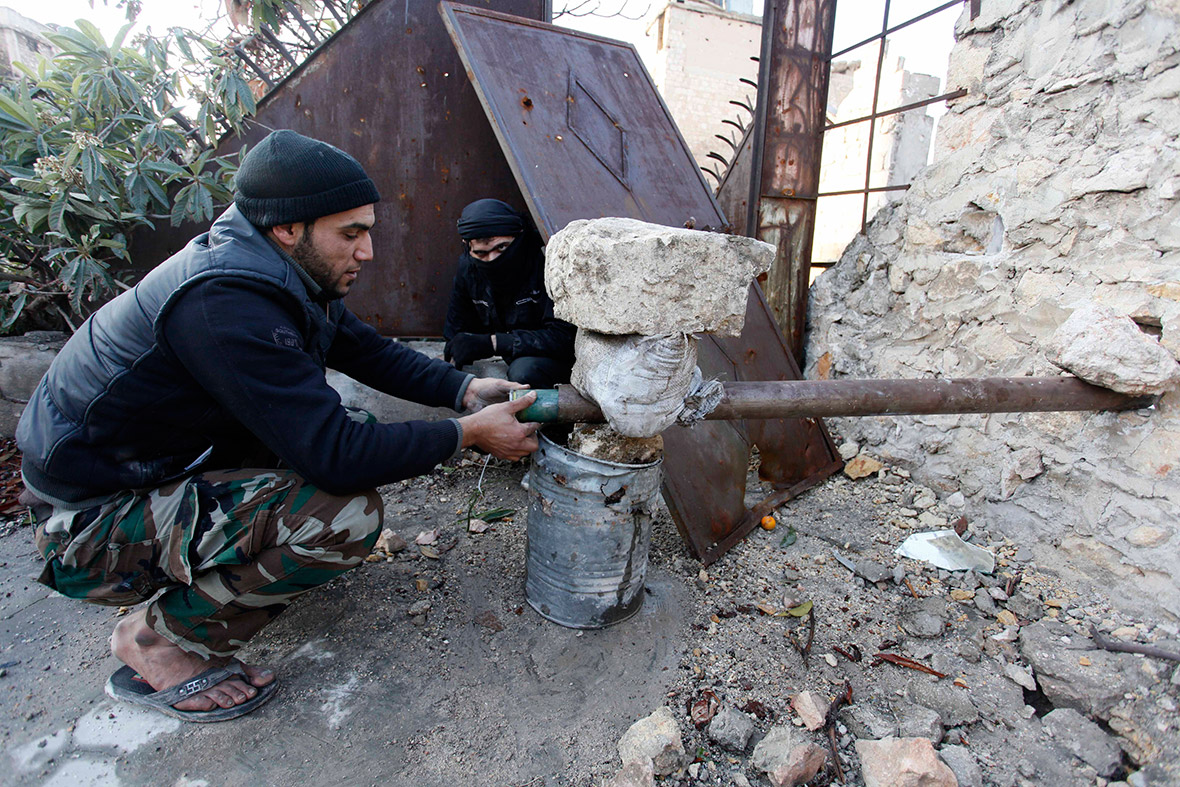 Free Syrian Army fighters improvise a very basic rocket launcher