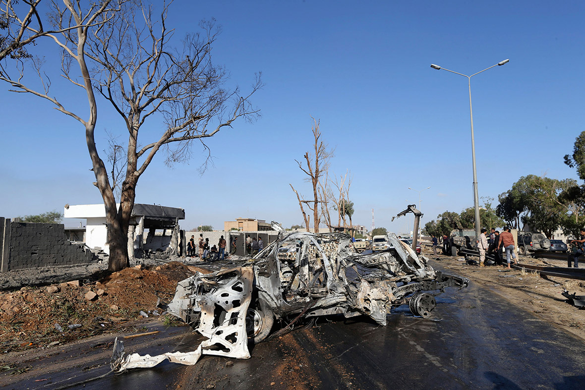 A damaged army vehicle is seen after after a suicide bombing at an army camp in Benghazi, Libya.