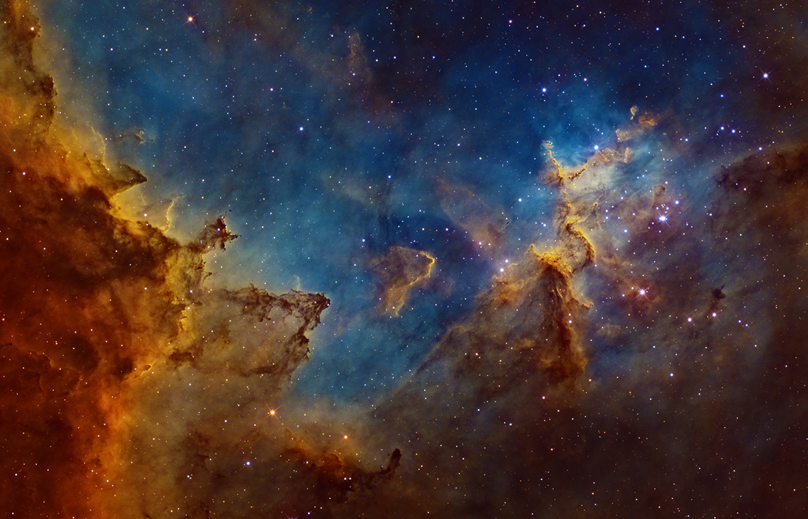 Centre of the Heart Nebula by Ivan Eder (Hungary). Situated 7,500 light years away in the 'W'-shaped constellation of Cassiopeia, the Heart Nebula is a vast region of glowing gas, energised by a cluster of young stars at its centre. The image depicts the central region, where dust clouds are being eroded and moulded into rugged shapes by the searing cosmic radiation.