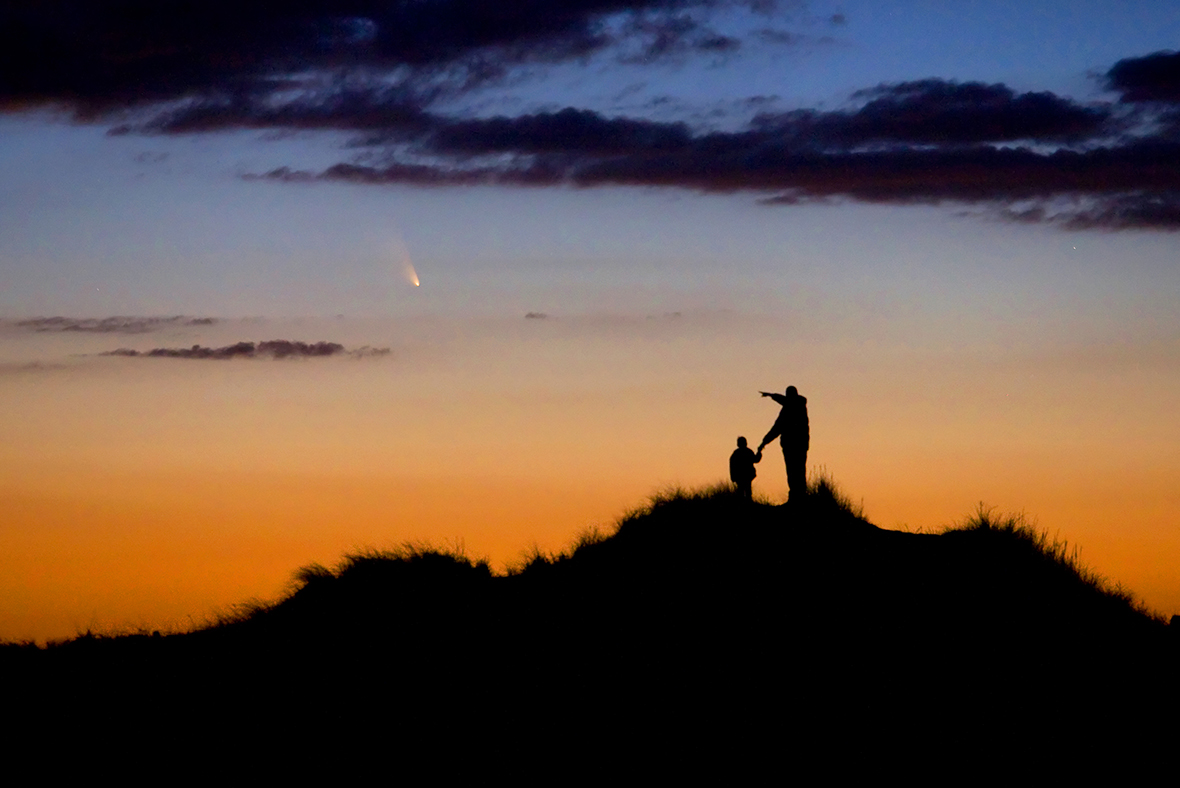 Father and Son Observe Comet PanSTARRS by Chris Cook (USA). A father and his young son watch the evening display of Comet PanSTARRS on First Encounter Beach, Eastham, Massachusetts, USA. The photographer had spent weeks preparing the shoot to capture the comet, which will not be seen again for over 100,000 years, in order to foster his son's interest in astronomy.