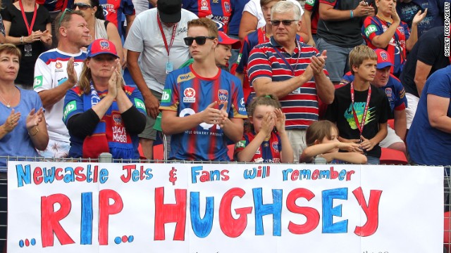 Newcastle fans applaud in memory of Phil Hughes at the 63 minute mark during the an A-League soccer match between the Newcastle Jets and Central Coast Mariners on November 30 in Newcastle, Australia. Hughes' was injured while on 63 not out, charging the number with symbolism for mourners.