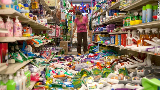 Nina Quidit cleans up the Dollar Plus and Party Supplies Store on August 24 in American Canyon, California, after the earthquake wreaked havoc on the store's shelves. 