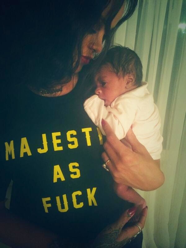 Rihanna Blasted By Fans For Wearing Inappropriate T-Shirt As She Cuddles Her Baby Cousin | Photo 2