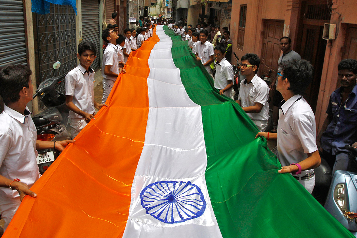 Children hold a 200-metre-long national flag during India's Independence Day celebrations in the southern Indian city of Chennai