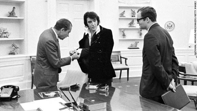 Elvis shows President Richard Nixon his cuff links at the White House, on December 21, 1970.