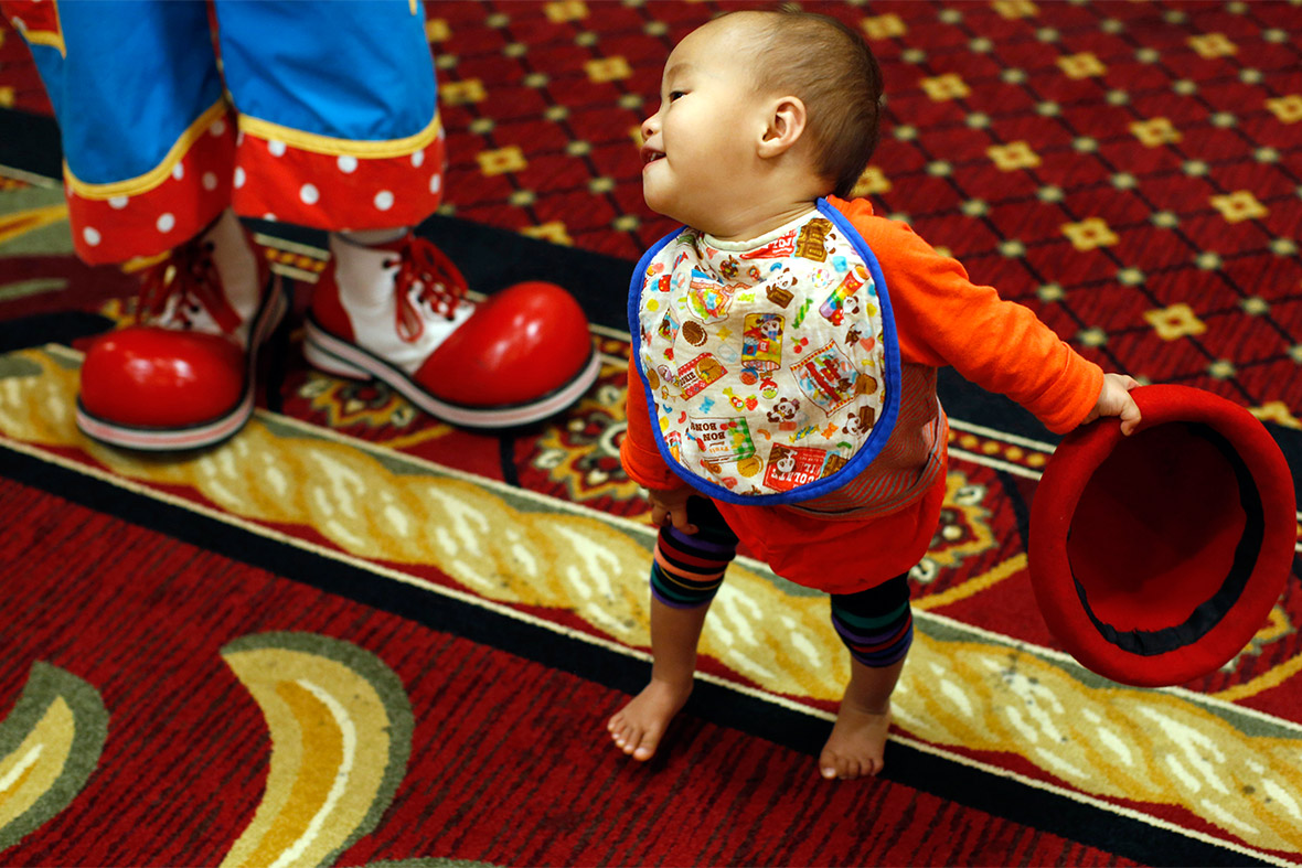Showichi Hashimoto plays near his father Junji at the World Clown Association's annual convention in Northbrook, Illinois
