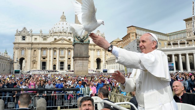 Francis frees a dove May 15 during his weekly general audience in St. Peter's Square.