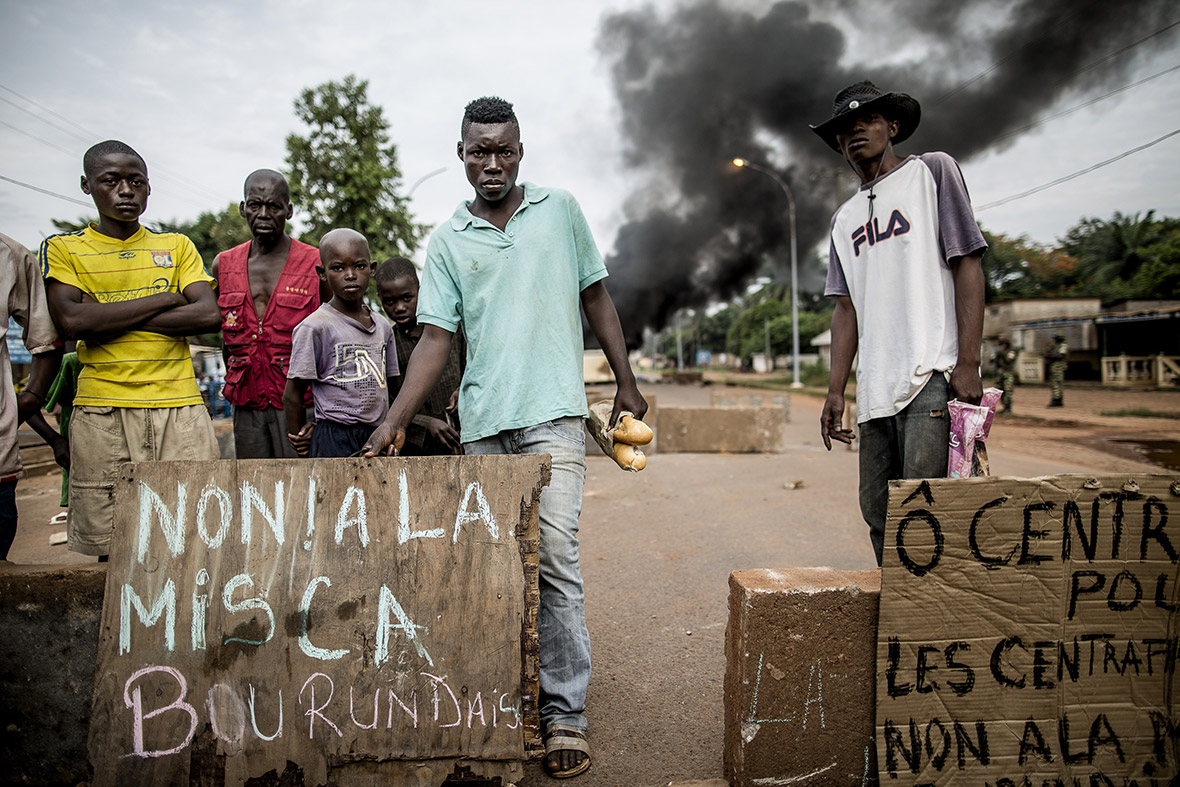 People angered by an attack on a church in Bangui near a barricade of burning tyres in Bangui, Central African Republic
