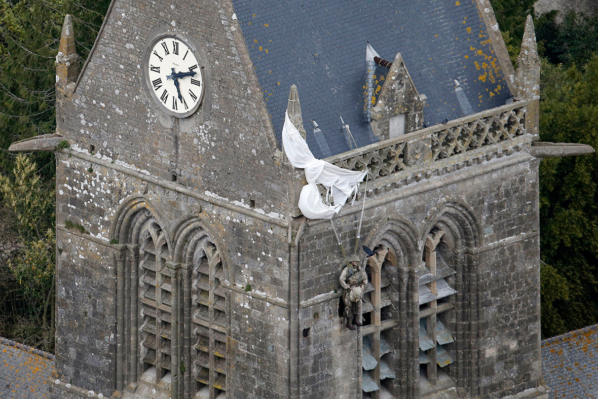 An effigy of Private John Steele in his uniform hangs from the steeple of the Sainte-Mere-Eglise church, in Normandy. Private Steele was one of the American paratroopers who landed in Sainte-Mere-Eglise, the first village in Normandy liberated by the Americans on D-Day, June 6, 1944