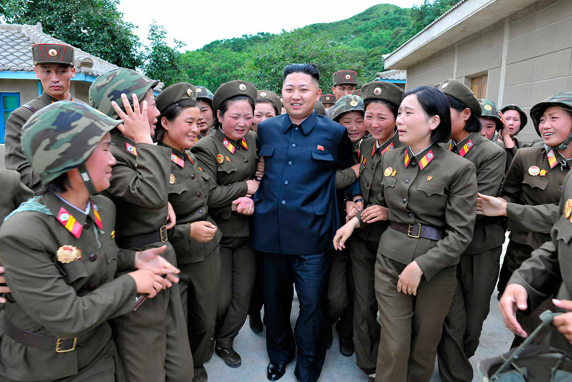 24 August 2012: Women surround Kim Jong-un as he visits the Thrice Three-Revolution Red Flag Kamnamu Company of the Korean People's Army