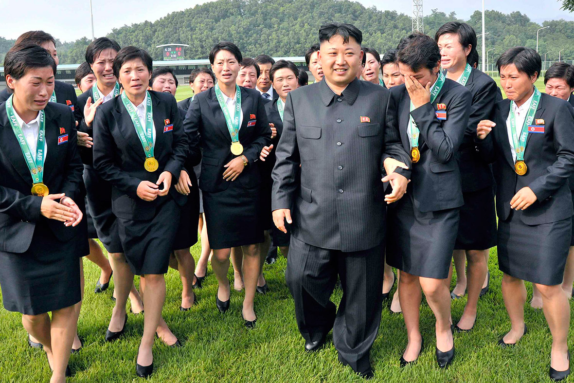 1 August 2013: Members of the women's national football team cry as Kim Jong-un walks with them after they won the East Asian Cup championship in Seoul