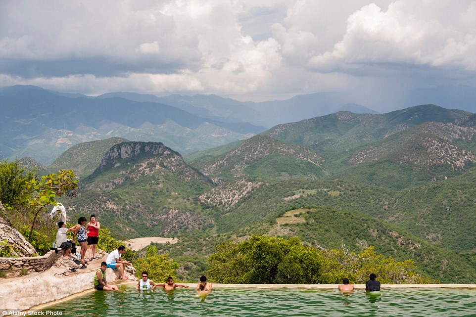 The best things in life are free: Holidaymakers bathe in the natural infinity pool while taking in the breathtaking mountain views