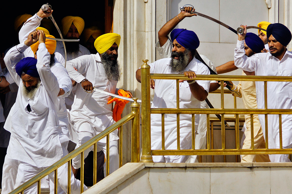 Sikhs wield swords during a clash at the Golden Temple in Amritsar on the 30th anniversary of a controversial raid by Indian security forces that flushed out separatist militants holed up in the temple