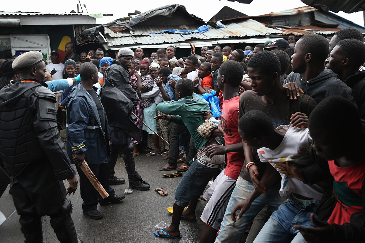 Scuffles break out as quarantined residents of the West Point slum wait for food aid