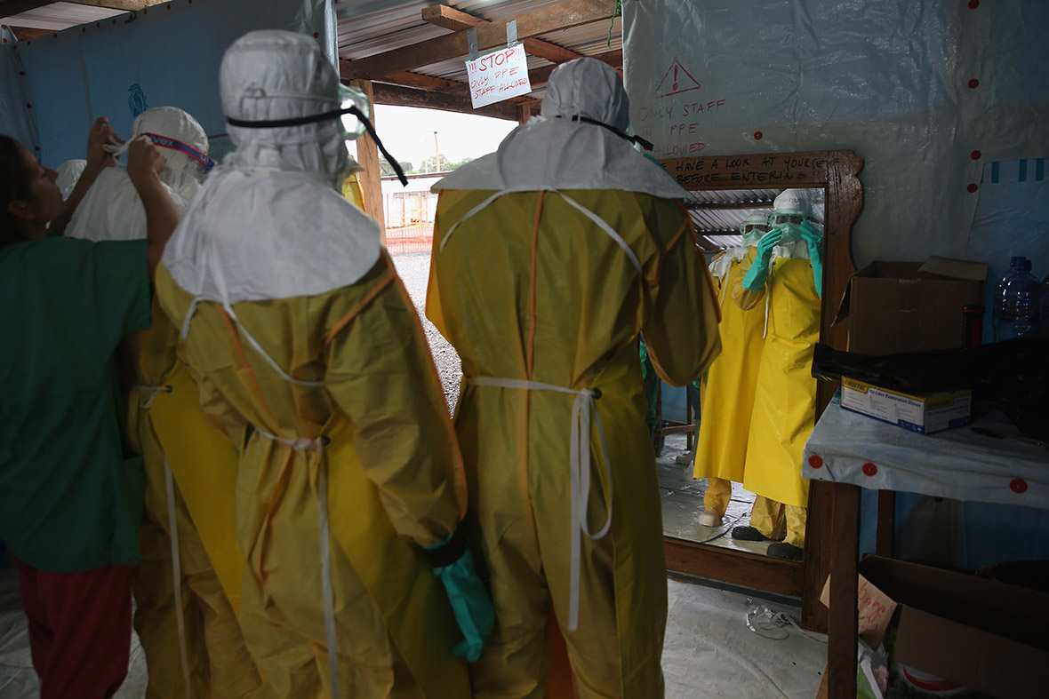 Doctors Without Borders (MSF) staff suit up in protective clothing before entering a high-risk area of the MSF Ebola treatment centre