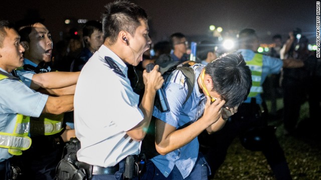 A police officer shouts at a protester who was hit with pepper spray on October 15.
