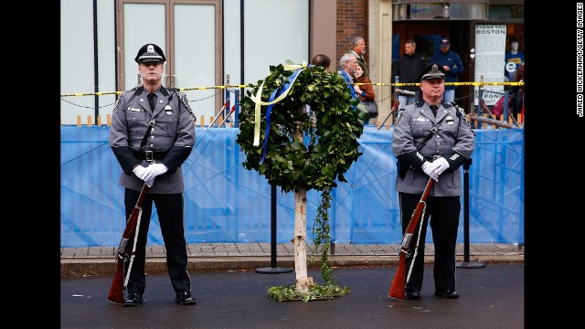 A wreath was laid at one of the bomb sites, under a steady rain on Boston's Boylston Street.