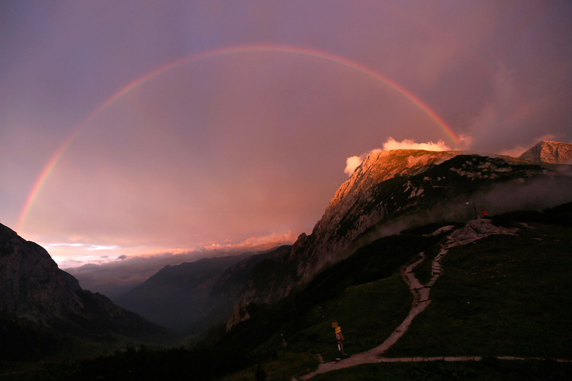 A rainbow spans over a valley between the Hohes Goell and Schneibstein mountains near the Carl-von-Stahl-Haus Alpine Club hut in the Berchtesgaden, Bavaria