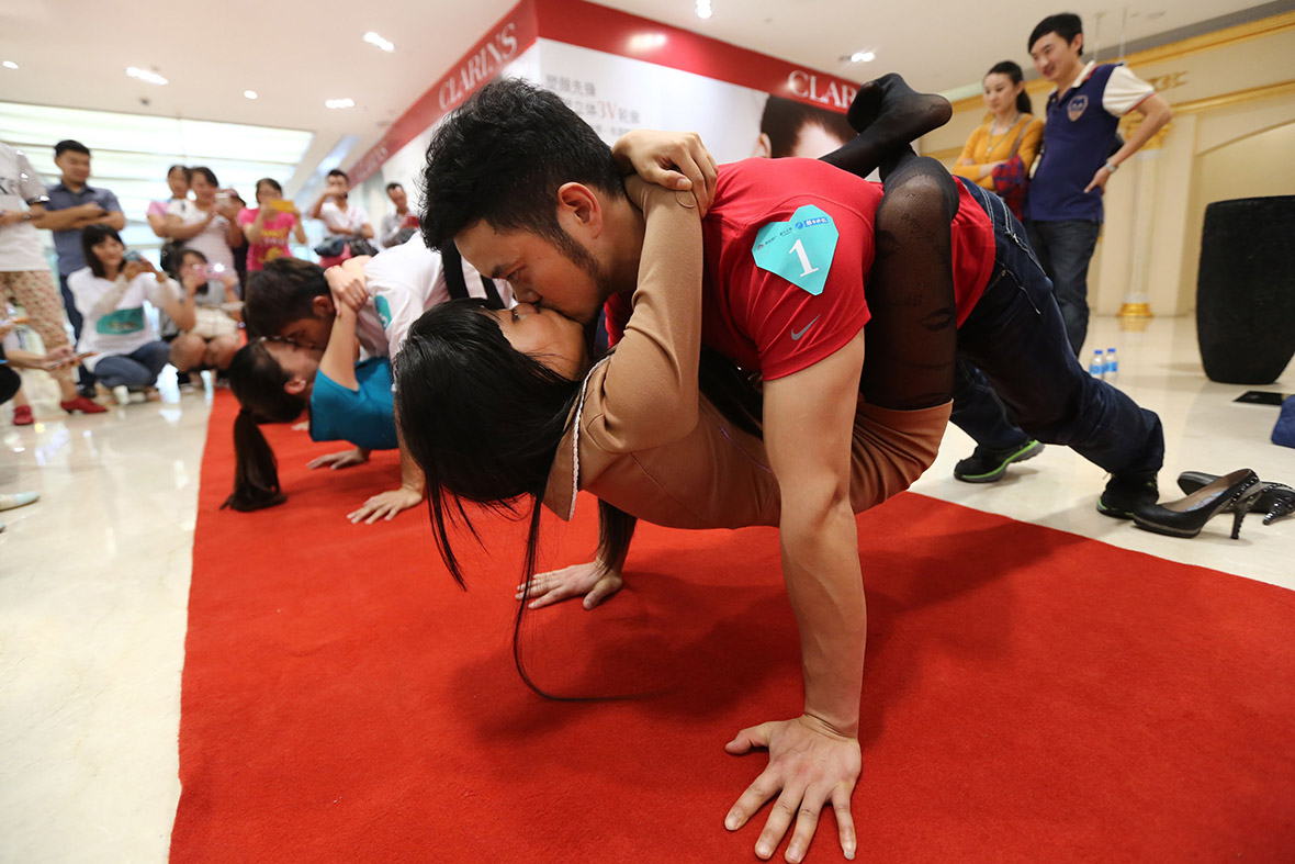 People compete in a kissing contest during the Qixi Festival (known as Chinese Valentine's Day) in Kunming, Yunnan province