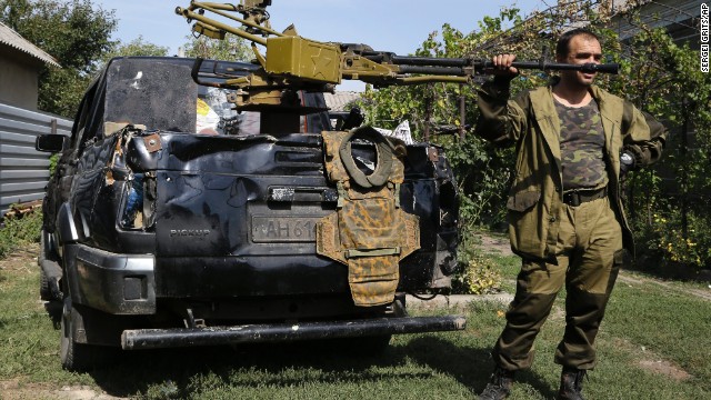A pro-Russian rebel stands next to a truck with a heavy machine gun attached to it Sunday, September 7, in Donetsk.