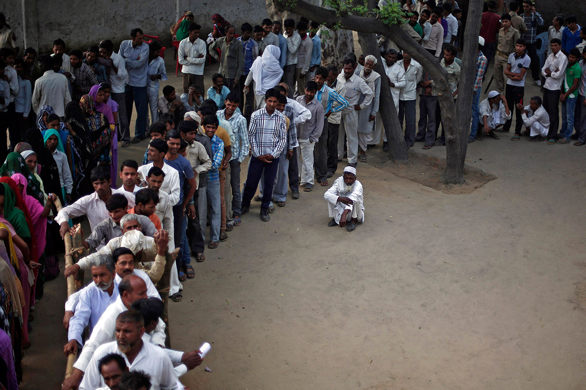 Voters queue at a polling station in Shabazpur Dor village, Amroha district, in the northern Indian state of Uttar Pradesh