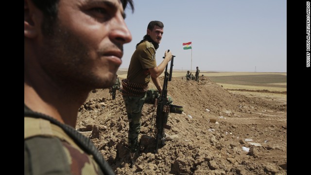 Kurdish Peshmerga forces stand guard at their position in the Omar Khaled village west of Mosul, Iraq, on Sunday, August 24. 