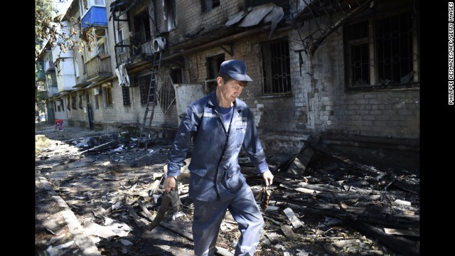 A firefighter walks past the rubble of a building destroyed by shelling in Donetsk on Wednesday, September 17. 