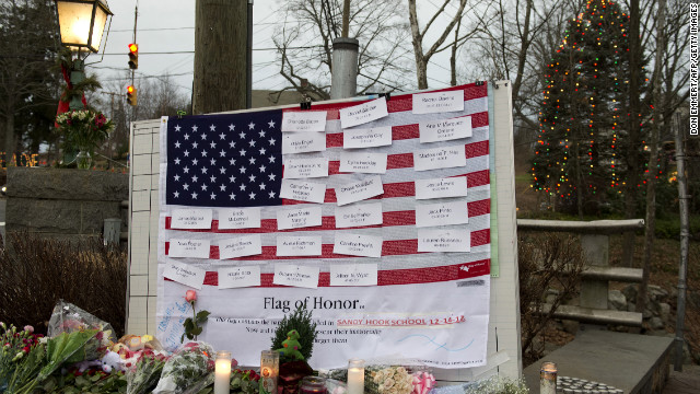 Names of victims are displayed on a flag in the business area of Newtown, Connecticut, on December 16.