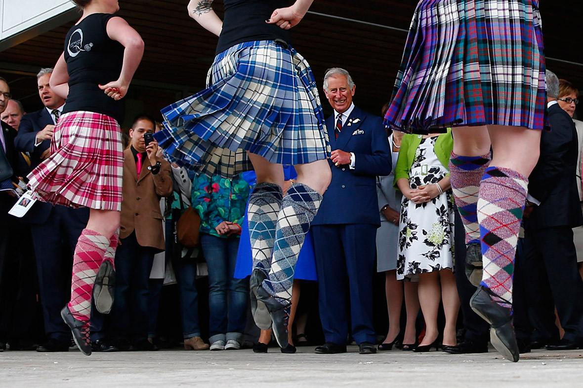 Prince Charles watches dancers in Halifax, Nova Scotia, as he and his wife Camilla arrive for a four-day visit to Canada